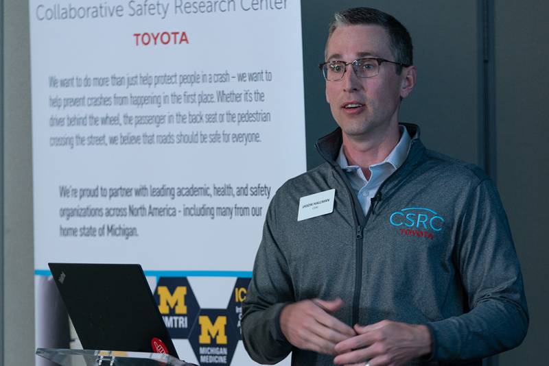 Photo of Jason Hallman presenting in front of a screen.
